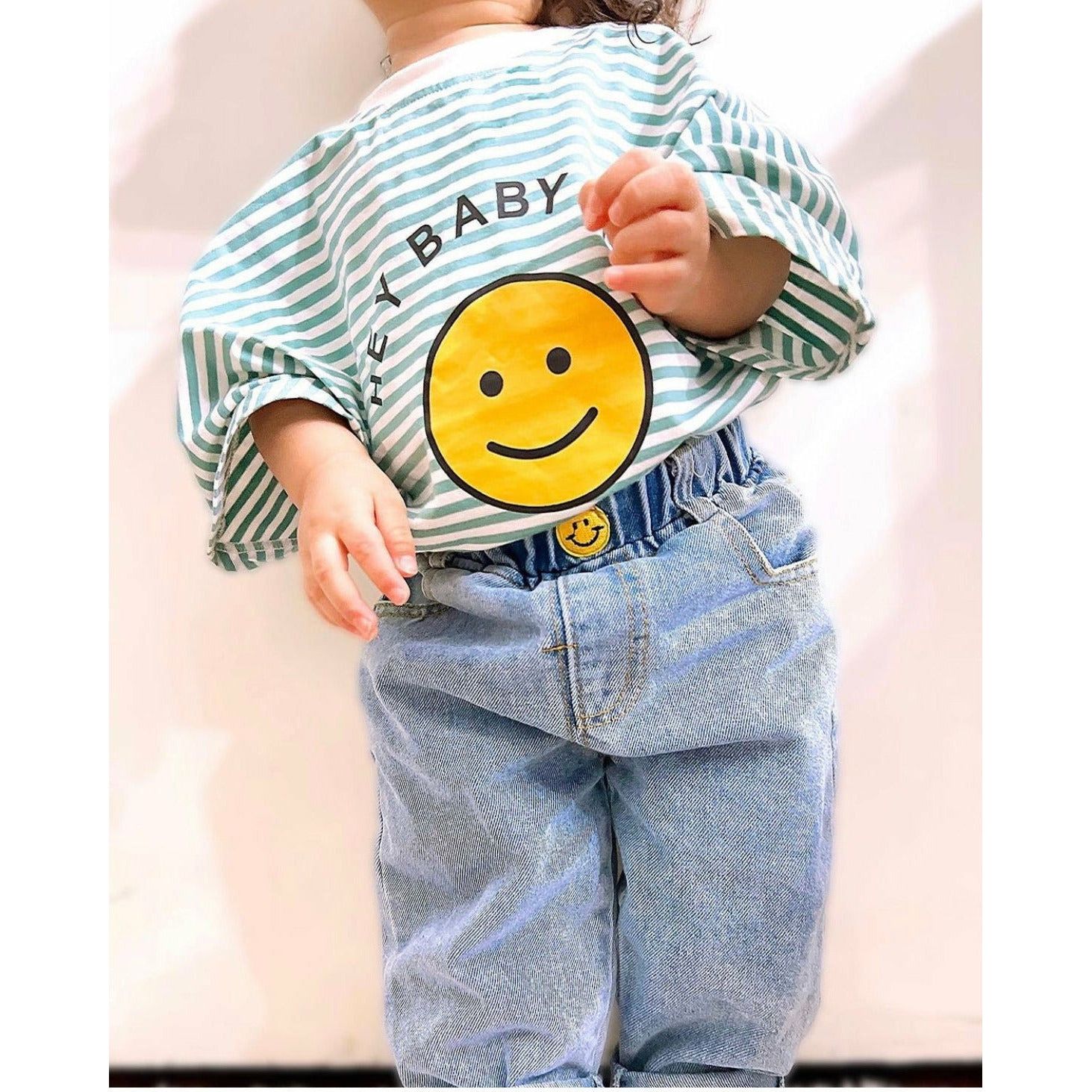 Baby boy in blue striped sweatshirt romper with smiley face