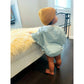 Baby girl in striped blue romper with yellow beanie